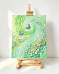 Hand‑painted acrylic canvas art with swirling green background, colorful wildflowers and two blue butterflies, unframed canvas displayed on wooden art easel